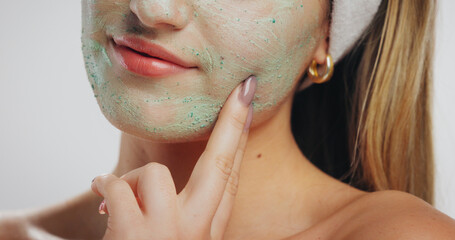 Clay mask, skincare and mouth of woman in studio for beauty, wellness and detox on white...