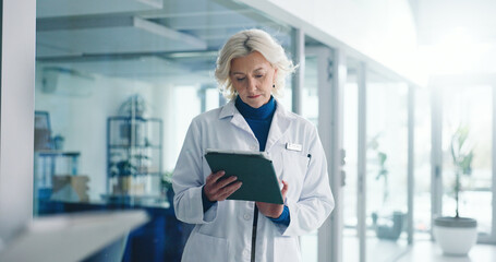 Tablet, mature woman and doctor in hospital with medical research, administration or communication. Digital technology, email and professional female healthcare worker with online contact in clinic.