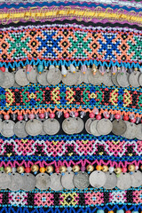 Close-up of traditional Mari womens chest ornament with colorful beaded embroidery and coin pendants
