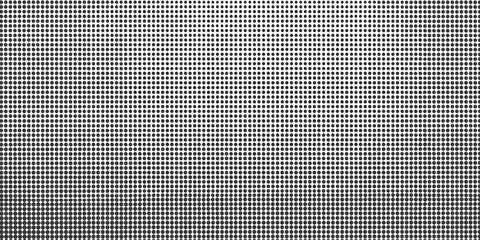 Close-up view of a grid pattern, appearing as small squares, in grayscale