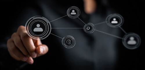 Hand interacting with a network of interconnected user icons on a dark background