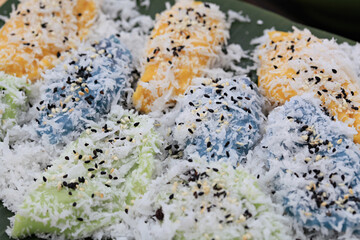 Khanom Tua Pap is a colorful Thai dessert. Inside is a soybean or red bean filling, sprinkled with grated coconut and sugar