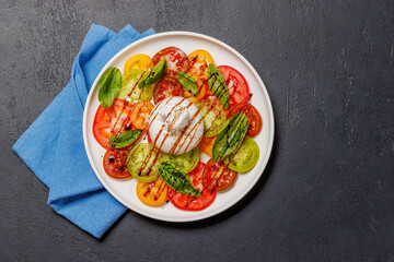 Fresh burrata served on slices of colorful tomatoes