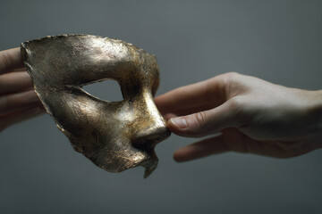 manipulating people. hand passes the mask