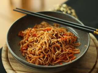 Stir-fried instant noodles with vegetables and meat, a quick and flavorful Thai comfort food dish loved for its savory taste.
