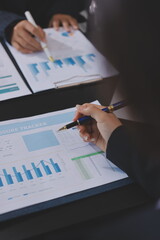 Team of business people working together in the meeting room office,
teamwork background charts and...