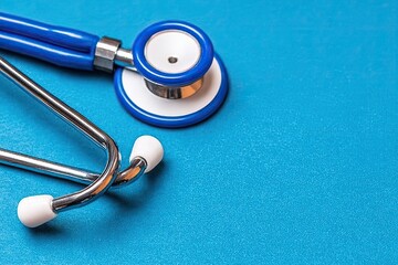 Blue stethoscope on a vibrant blue surface