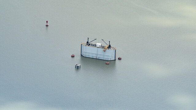 Panama Canal expansion project showing a floating steel structure surrounded by buoys, used within the construction area for the new lock systems.
