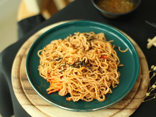 Stir-fried instant noodles with vegetables and meat, a quick and flavorful Thai comfort food dish loved for its savory taste.
