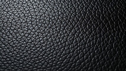 Close-up of black leather texture with intricate patterns, highlighting detail and sophistication.