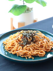 Stir-fried instant noodles with vegetables and meat, a quick and flavorful Thai comfort food dish loved for its savory taste.