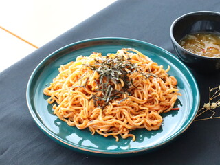 Stir-fried instant noodles with vegetables and meat, a quick and flavorful Thai comfort food dish loved for its savory taste.