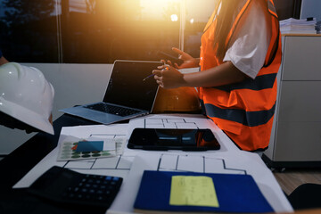 Closeup of team of industrial engineers meeting analyze machinery blueprints consult project on...