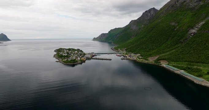 Charming fishing village of Husoy island connected with causeway to Senja, drone