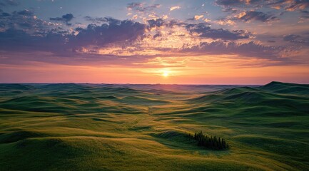 Obraz premium Sunrise over rolling green hills
