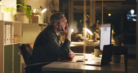 Mature man, reading and computer at night in office with review, work article and deadline. Person,...