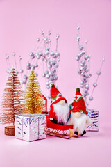 Christmas image on which two kind gnomes received gifts in a small forest of toy Christmas trees on...