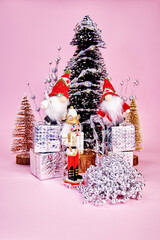 beautiful Christmas picture in which gnomes, standing on gift boxes and a nutcracker decorate a...