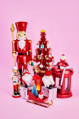 bright Christmas picture in red tones with a decorated Christmas tree, gnomes, nutcrackers, Santas,...
