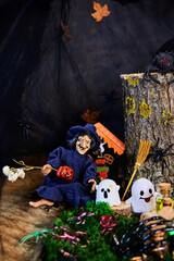 to a cheerful witch in cute ghosts came to visit the dark forest on All Saints Day, Halloween in...