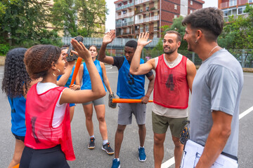 Baseball team celebrating with coach after winning game