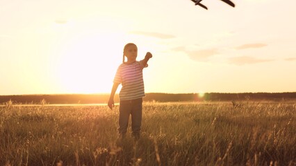 Sunset glow, silhouette of daughter, child runs freely, toy jet flight, pilot career dream, superhero childhood, hand holding airplane, open air nature, summer vacation vibe, parent family concept