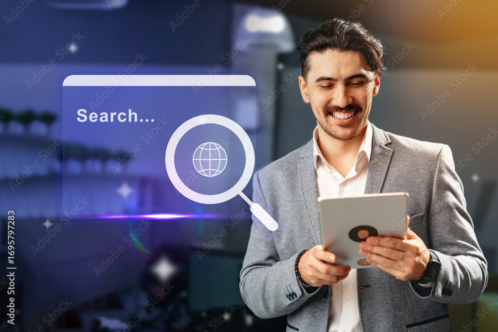 Poster man using tablet for online research in a modern workspace with digital interface displayed in the b