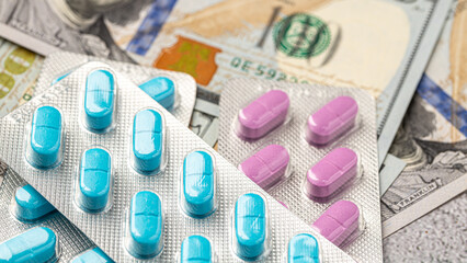 Dollar bill and a set of medicine pills. Rising costs of medical care. Reliefs for buying...