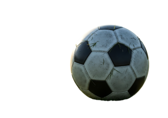 Soccer ball resting on grass against black background with room for text