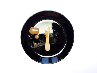 Melted ice cream stick, chocolate ice cream on a plate copy space, top view, flat lay. High quality