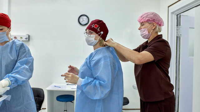 Healthcare workers preparing for surgery in a clean and modern operating room