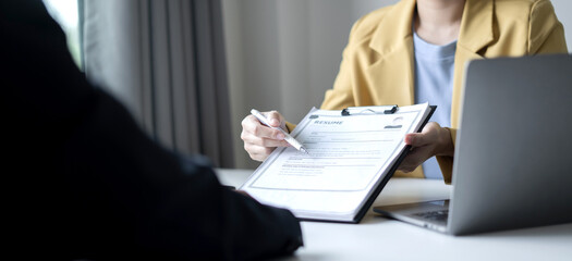 Business people hold a resume and talk to job applicants for job interviews about careers and Their personal history in the company. Recruitment concepts