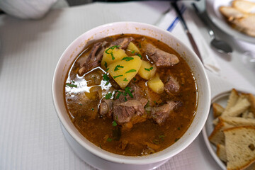 Traditional Portuguese lamb stew, a slow-cooked dish with tender meat, potatoes, and rich spices, popular in rustic cuisine and authentic Mediterranean gastronomy.