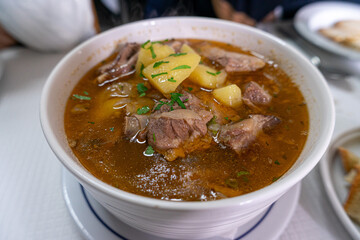 Traditional Portuguese lamb stew, a slow-cooked dish with tender meat, potatoes, and rich spices, popular in rustic cuisine and authentic Mediterranean gastronomy.