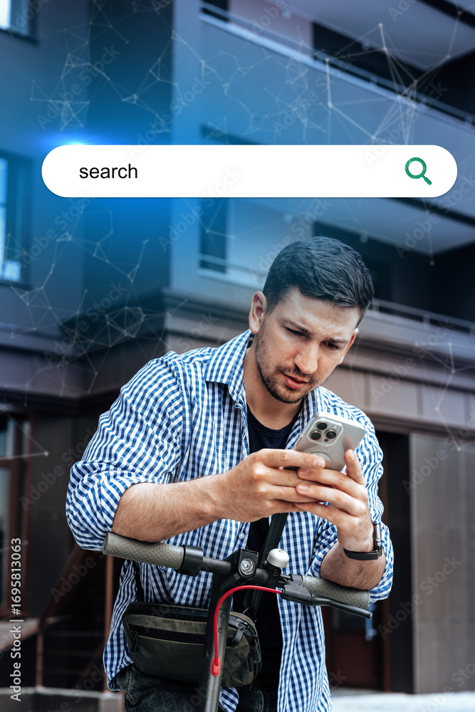Poster young man using smartphone while standing on scooter in front of modern building during daytime
