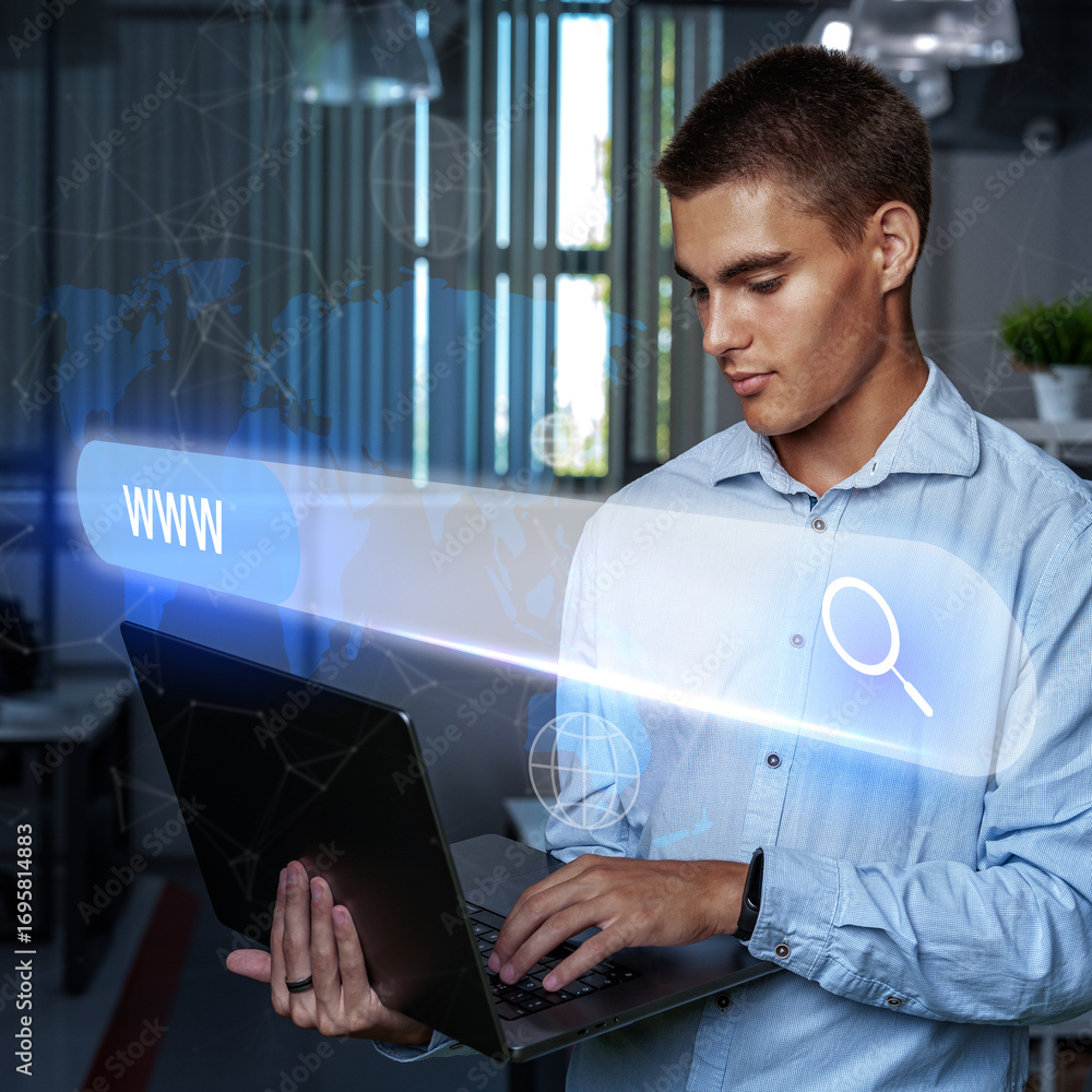Poster young man using laptop in modern office while searching online with illuminated web visuals