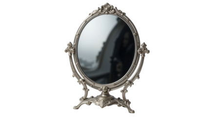 An empty antique gold ornate oval mirror frame on a white background