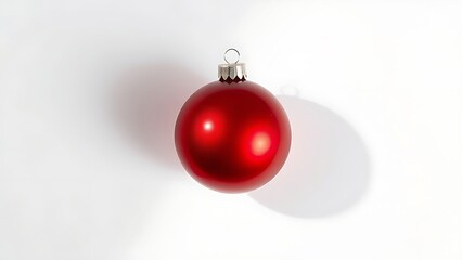 A single glossy red ornament placed on a pure white background, embodying holiday simplicity.