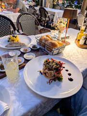 A gourmet vegetable dish served on a white plate with sauce details. Culinary art, lifestyle dining, and cultural experience through restaurant presentation and gourmet food.