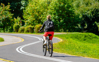 Cyclist ride on the bike path in the city Park
