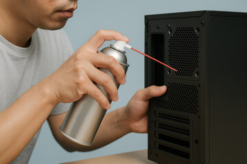Technician cleaning computer case with compressed air for dust removal and maintenance, promoting device safety and reliable performance