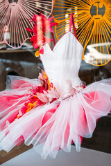Pink and white ballerina tutu dress adorned with artificial flowers and tulle in a boutique display...