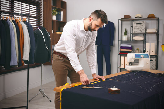 Fashion designer working in studio. Creating stylish clothes