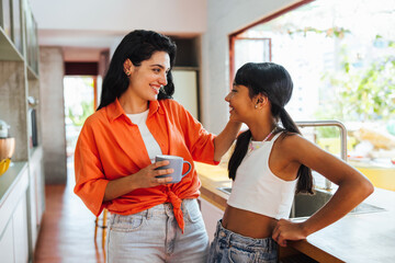 Mother and daughter enjoy quality time together in a bright modern kitchen