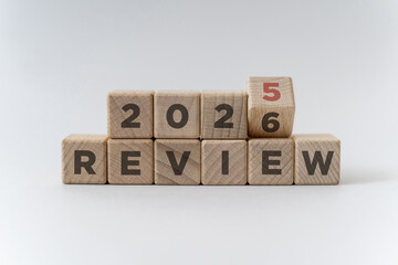 Flipping of 2025 to 2026 on wooden blocks. 2025 business and customer review for business strategic planning in the next year 2026. End of the year business concept on white background