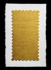 Gold fabric swatch on white paper