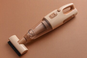 A beige handheld vacuum cleaner with a brush attachment rests on a matching textured surface