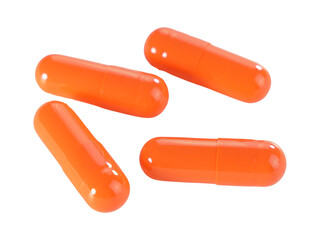 Bulk orange capsule pills isolated on white background.