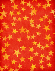 Vntage red paper decorated with  gold stars. Old paper texture