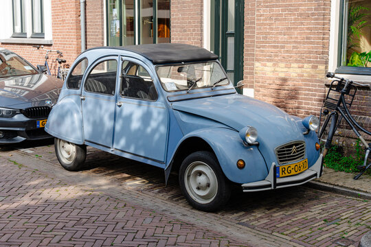 classic citro&euml;n 2cv vintage car parked on cobblestone street - Amsterdam, Netherlands - September 6 2025
